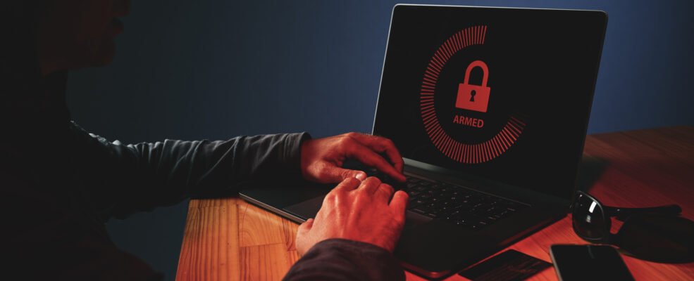 A hacker hacking a password on a laptop. This symbolises website security vulnerabilites