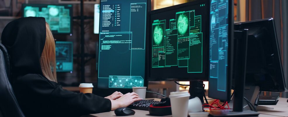 A hacker in front of her computer, working hard