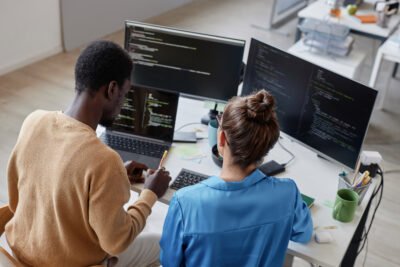 2 collegues working on some code, in this case for the company website