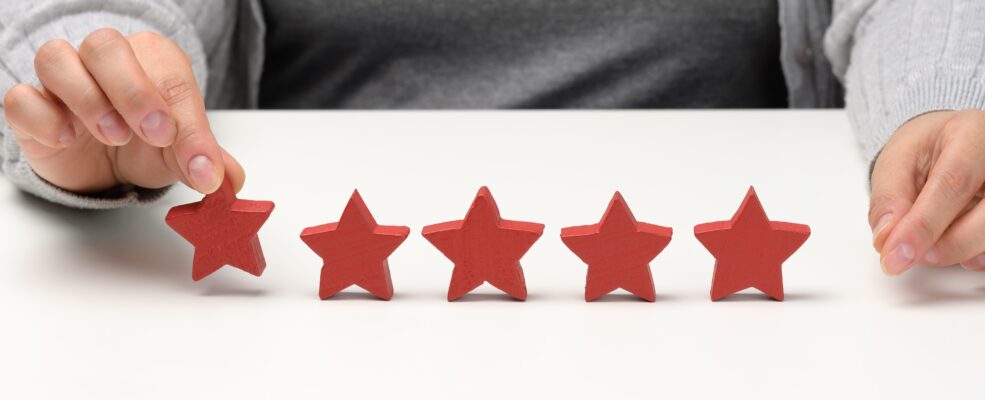 A woman removes a star to symbolise the effect that customer reviews can have on your business