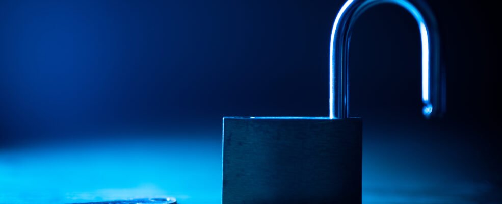 An unlocked lock with a key lying next to it to symbolise how the admin username makes it easy for hackers to enter your website