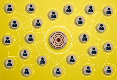 A target surrounded by a network of icons of people to illustrate effective planning in marketing